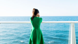 woman standing on balcony cruise ship