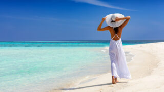 Woman Walking on the Beach in the Caribbean