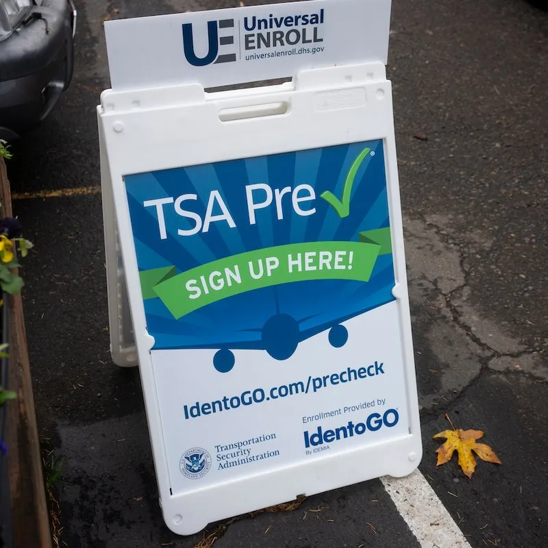 Lake Oswego, OR, USA - Nov 2, 2021: A sign that advertises the TSA PreCheck enrollment service is seen outside an IdentoGO office. IdentoGO by IDEMIA provides identity-related services.