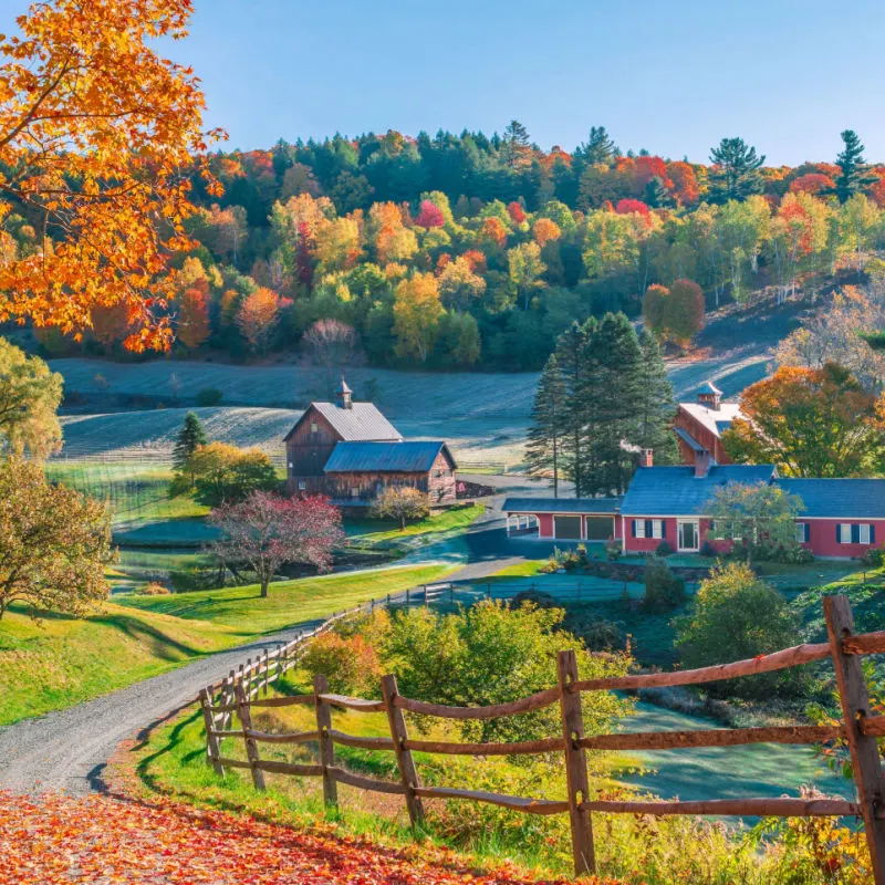 An early autumn foliage scene of houses in Woodstock, Vermont mountains