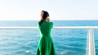 woman standing on balcony cruise ship