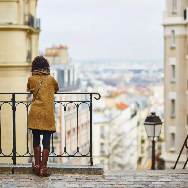 Female tourist enjoying city view on a street of Montmartre, Paris, France