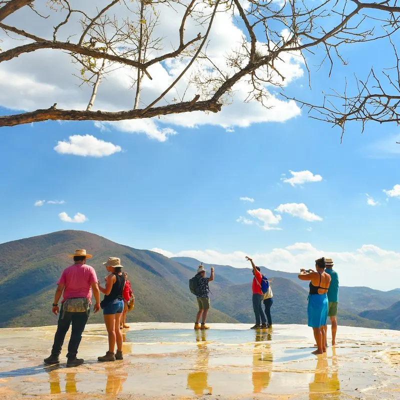 Tourists during the day at Hierve el Agua "the water boils" is a set of natural rock formations in the Mexican state of Oaxaca that resemble cascades of water in Oaxaca de Juárez, Oaxaca, Mexico.
