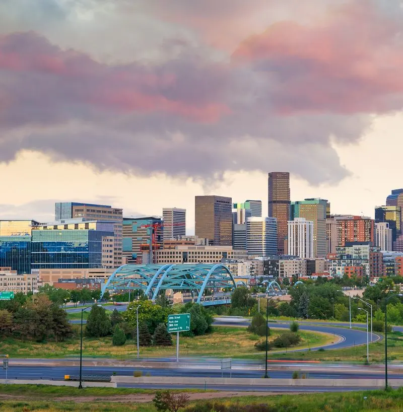 pink clouds with a city buildings underneath