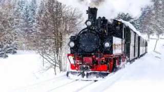 Steam train ride in winter snow travel scene