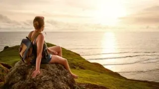 female traveler watching sunset