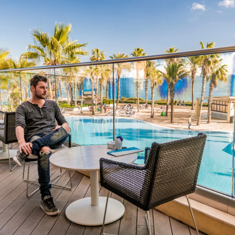tourist sitting poolside at malta hotel