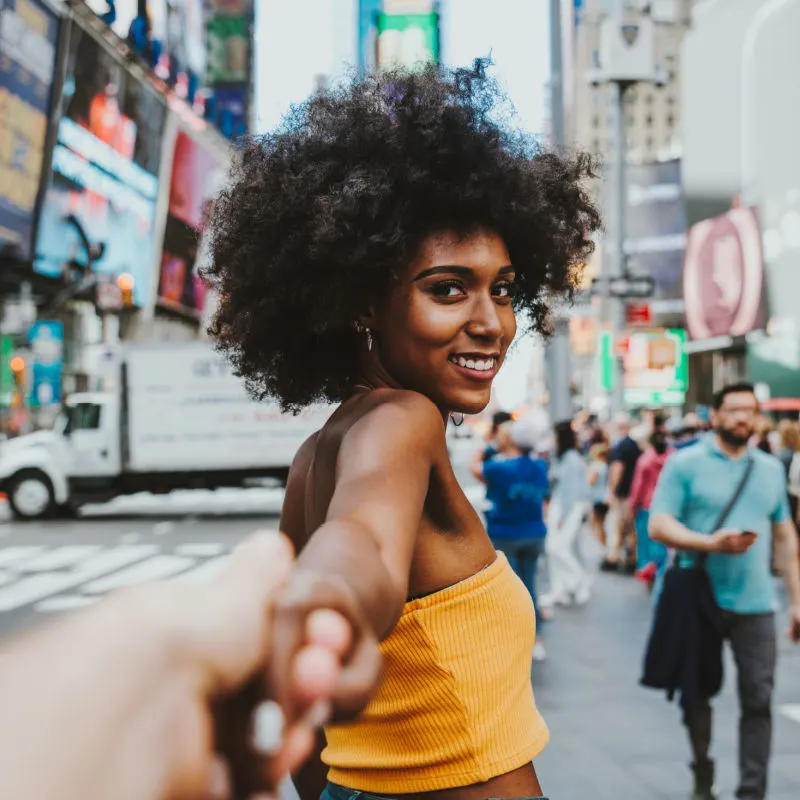 Woman smiling in a busy city