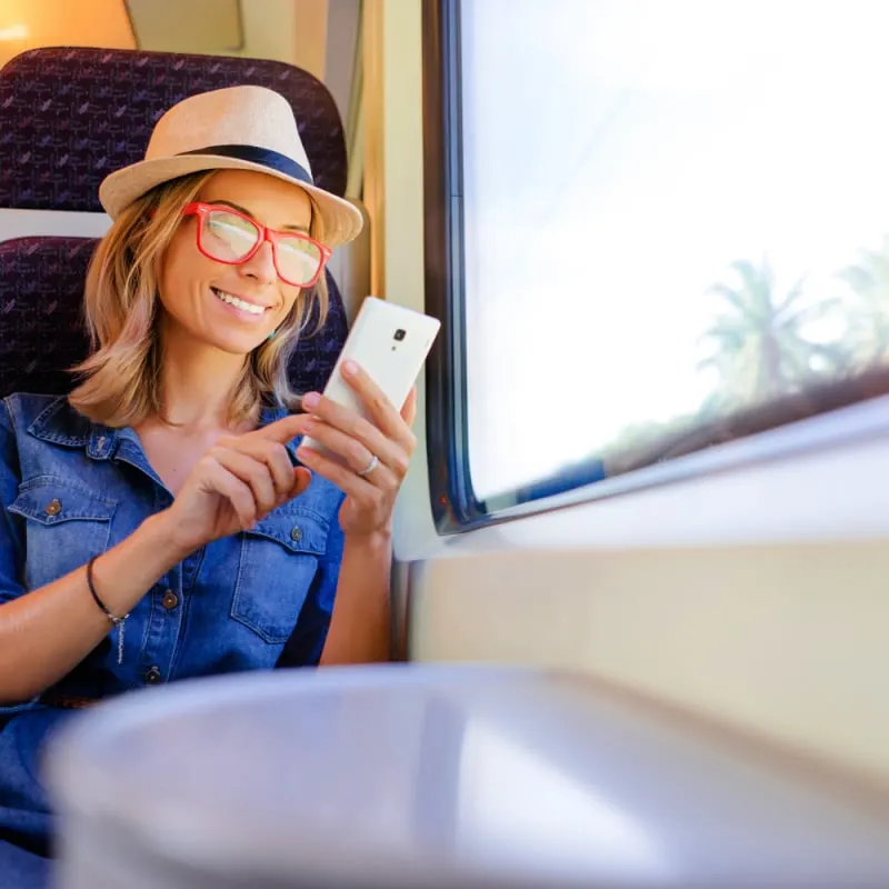 Woman looking at phone on a train